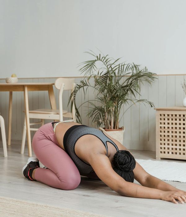 Woman in activewear feeling calm and energetic in a bright room.